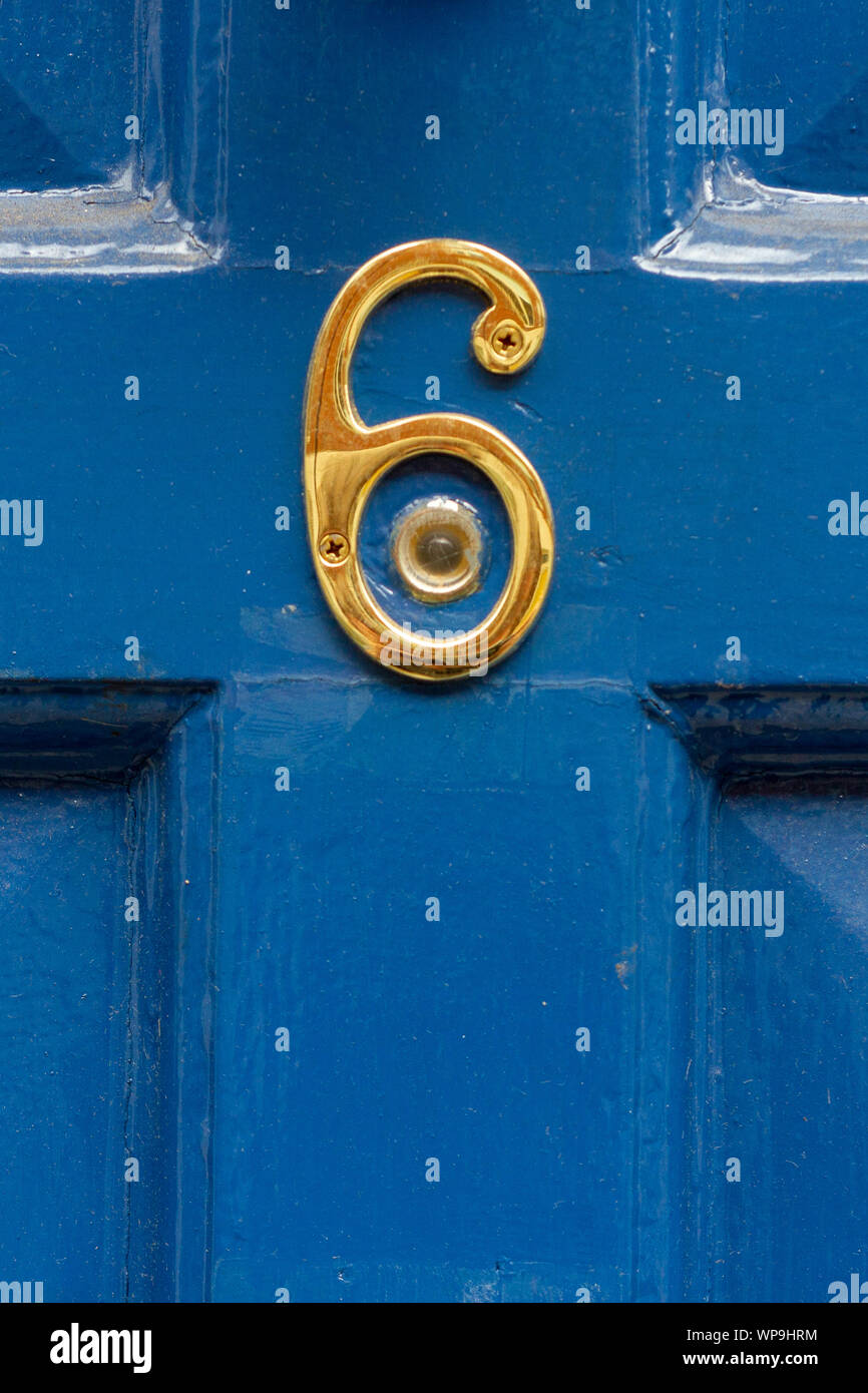 House number 6 in gold around a peephole Stock Photo