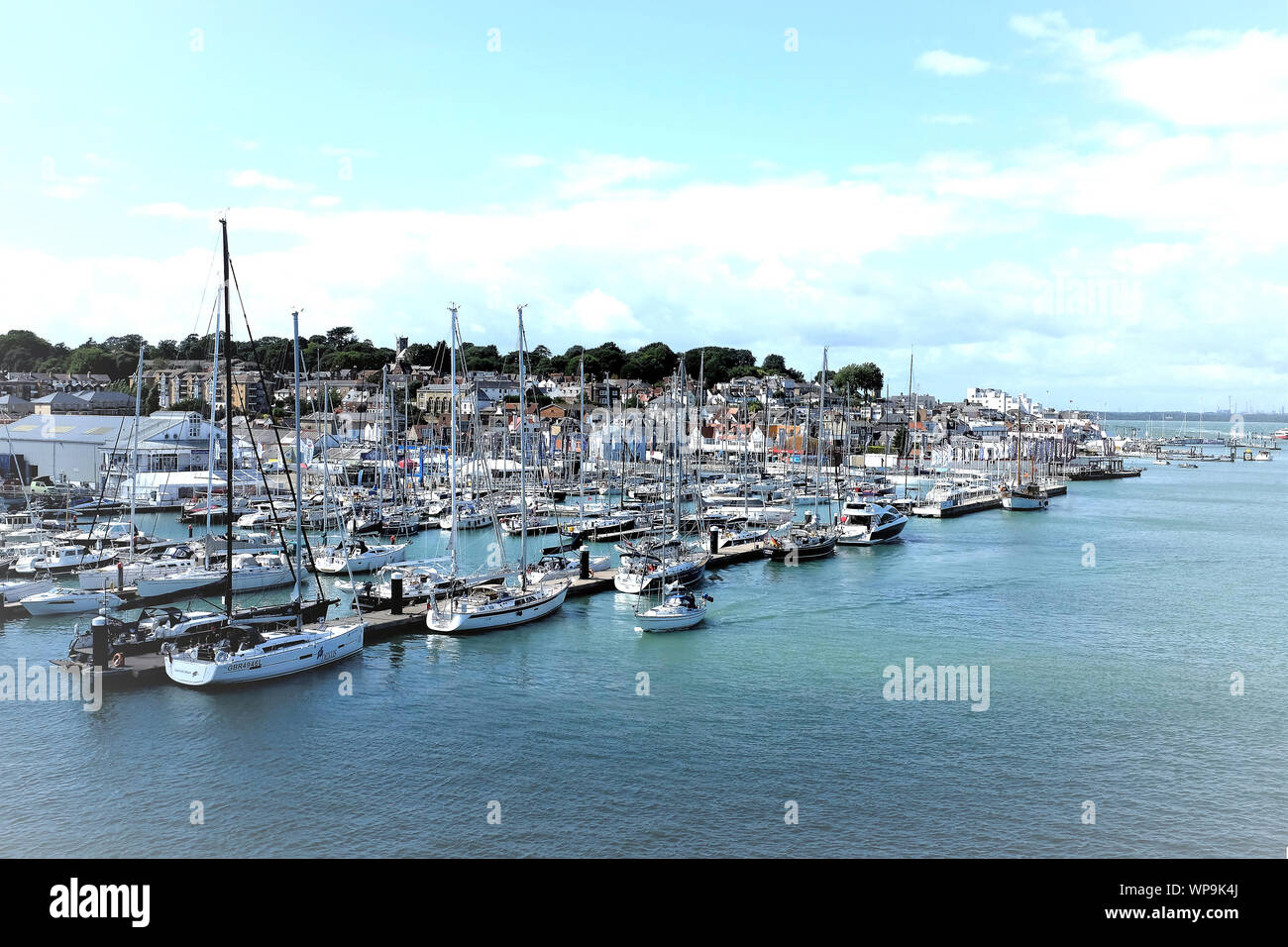Cowes, Isle of Wight, UK. August 18, 2019. Sports people mooring Yachts and boats in the Marina of the yachting capital of the world of Cowes on the I Stock Photo