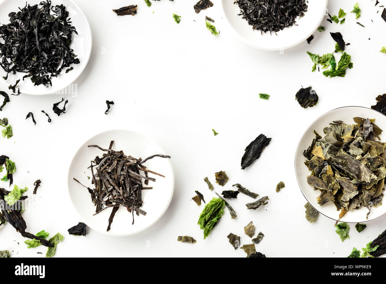 Dry seaweed, sea vegetables, shot from above on white, forming a frame. Superfoods background with a place for text Stock Photo