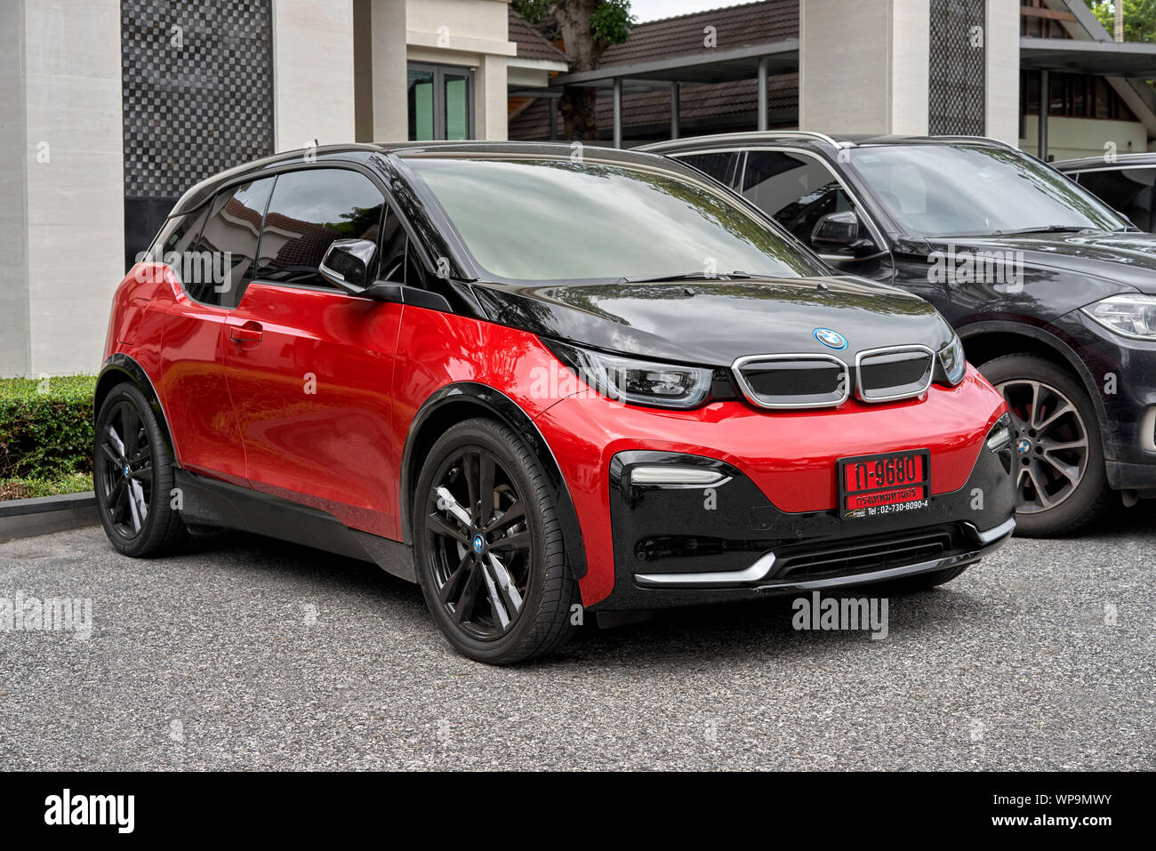 BMW i3s on red license plates signifying a new vehicle. Thailand car number plate Stock Photo