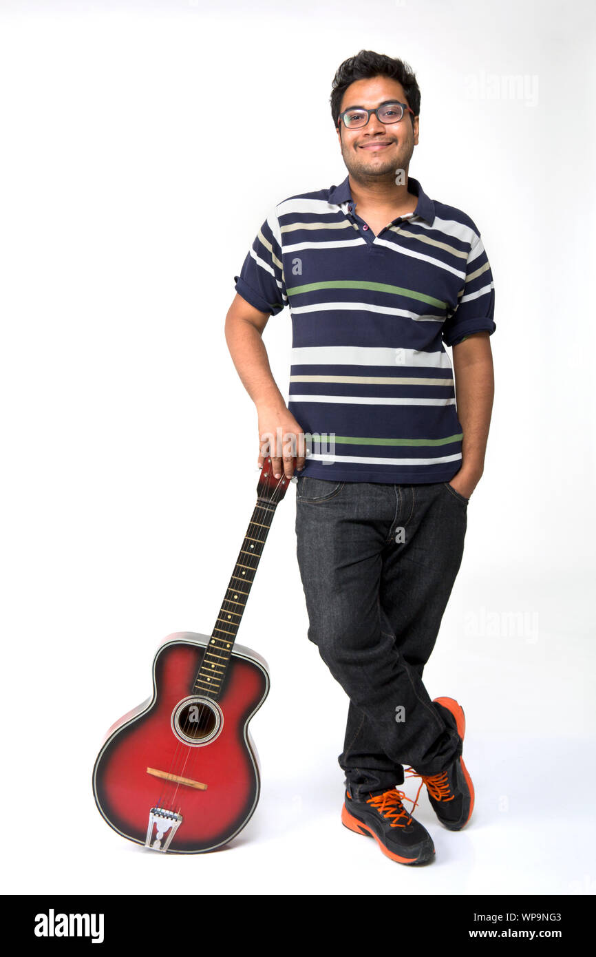 Young man leaning on a guitar Stock Photo