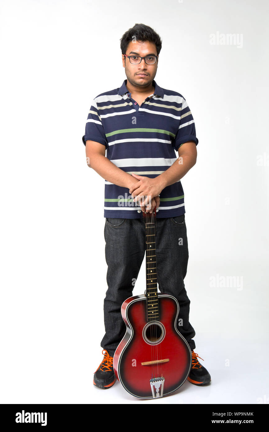 Young man holding on a guitar Stock Photo