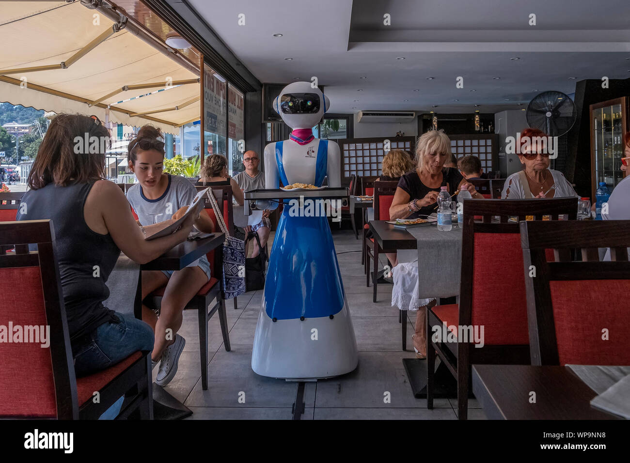 RAPALLO, ITALY - JULY 25: Waiter robot brings the dishes on July 25, 2019 in Rapallo, Italy. The 'Gran Caff Rapallo' restaurant in Liguria is the fir Stock Photo
