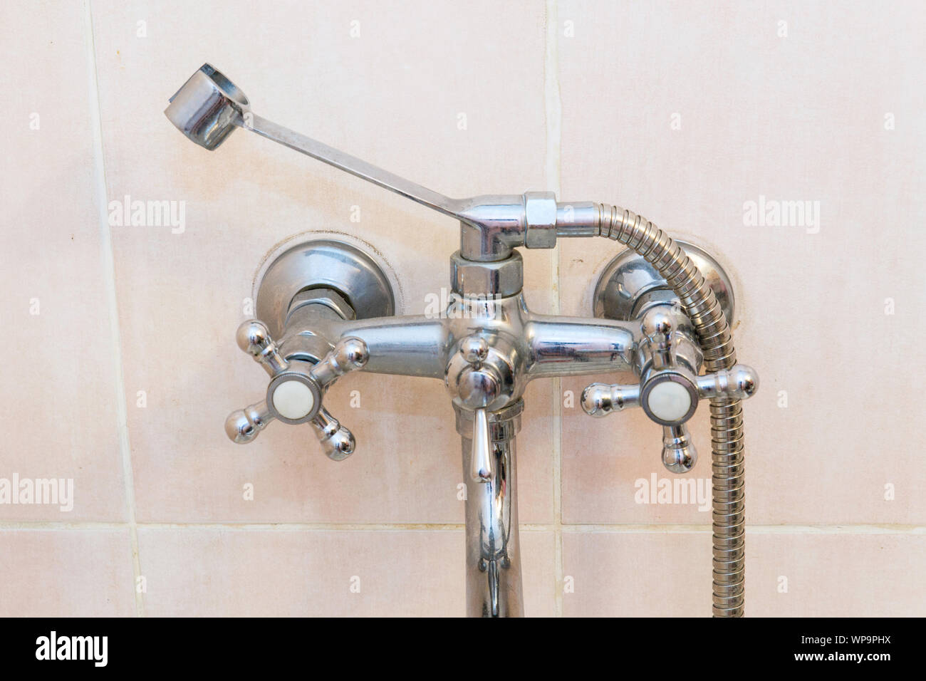 Old faucet the faucet Assembly in the bathroom. Limescale on chrome taps and mixer shower Stock