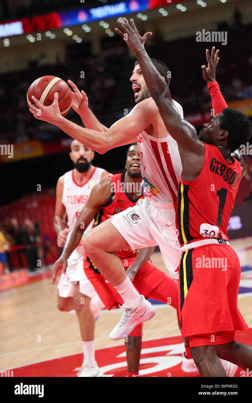Beijing, China. 8th Sep, 2019. Mourad El Mabrouk (2nd R) of Tunisia goes up  for a basket as Gerson Domingos (1st R) of Angola defends during the group  N match between Tunisia