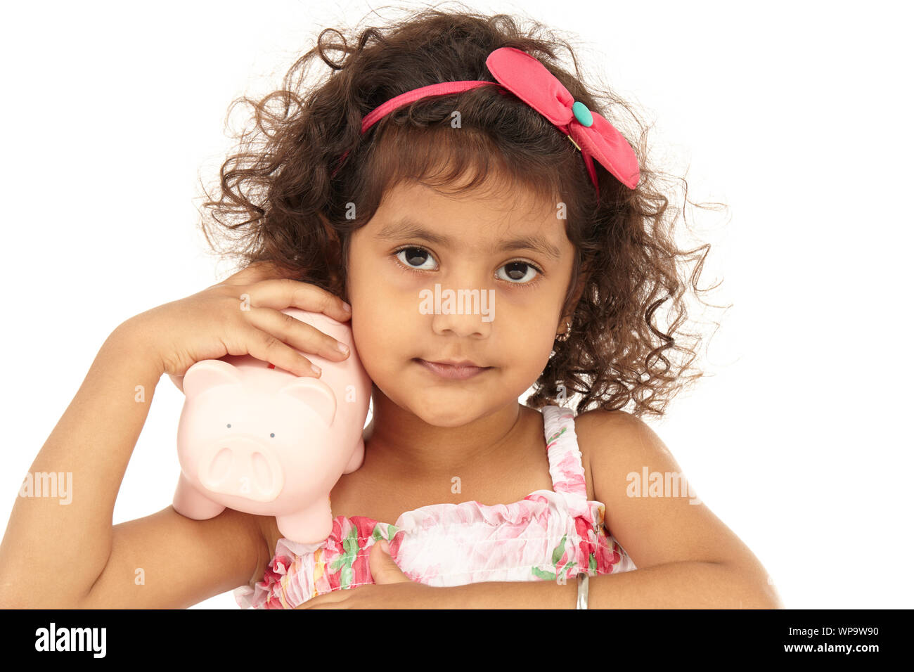 Portrait of a girl holding a piggy bank Stock Photo - Alamy