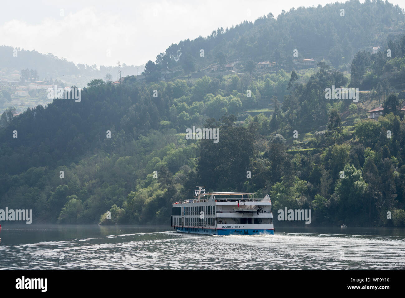 a douro cruise ship in the landscape on the Douro river at the town of