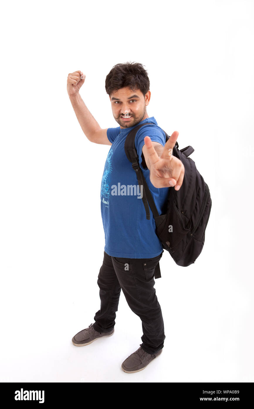 College student punching the air and showing V sign Stock Photo Alamy