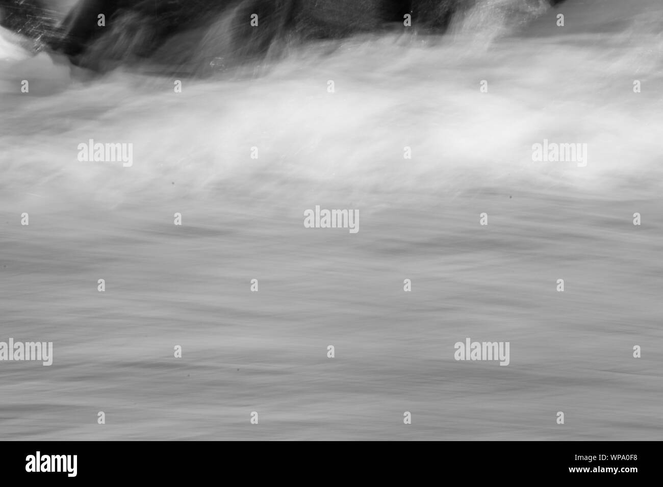 Black and White Abstract photographs of seascape with strong backwash with low shutter speed and exaggerated blurring of the motion. Stock Photo
