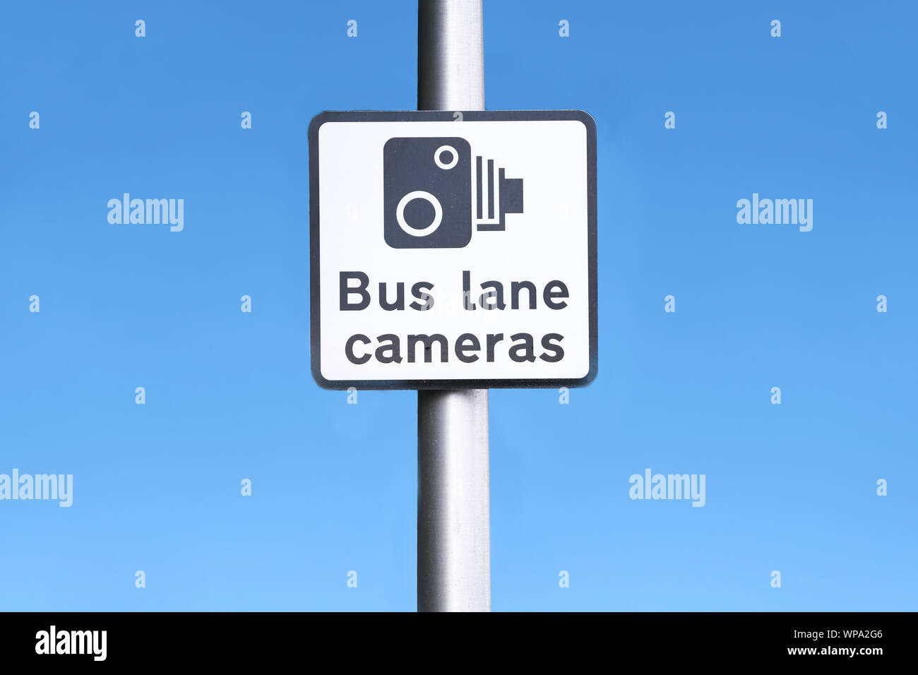 Bus lane camera symbol icon sign against blue sky at station in city Stock Photo