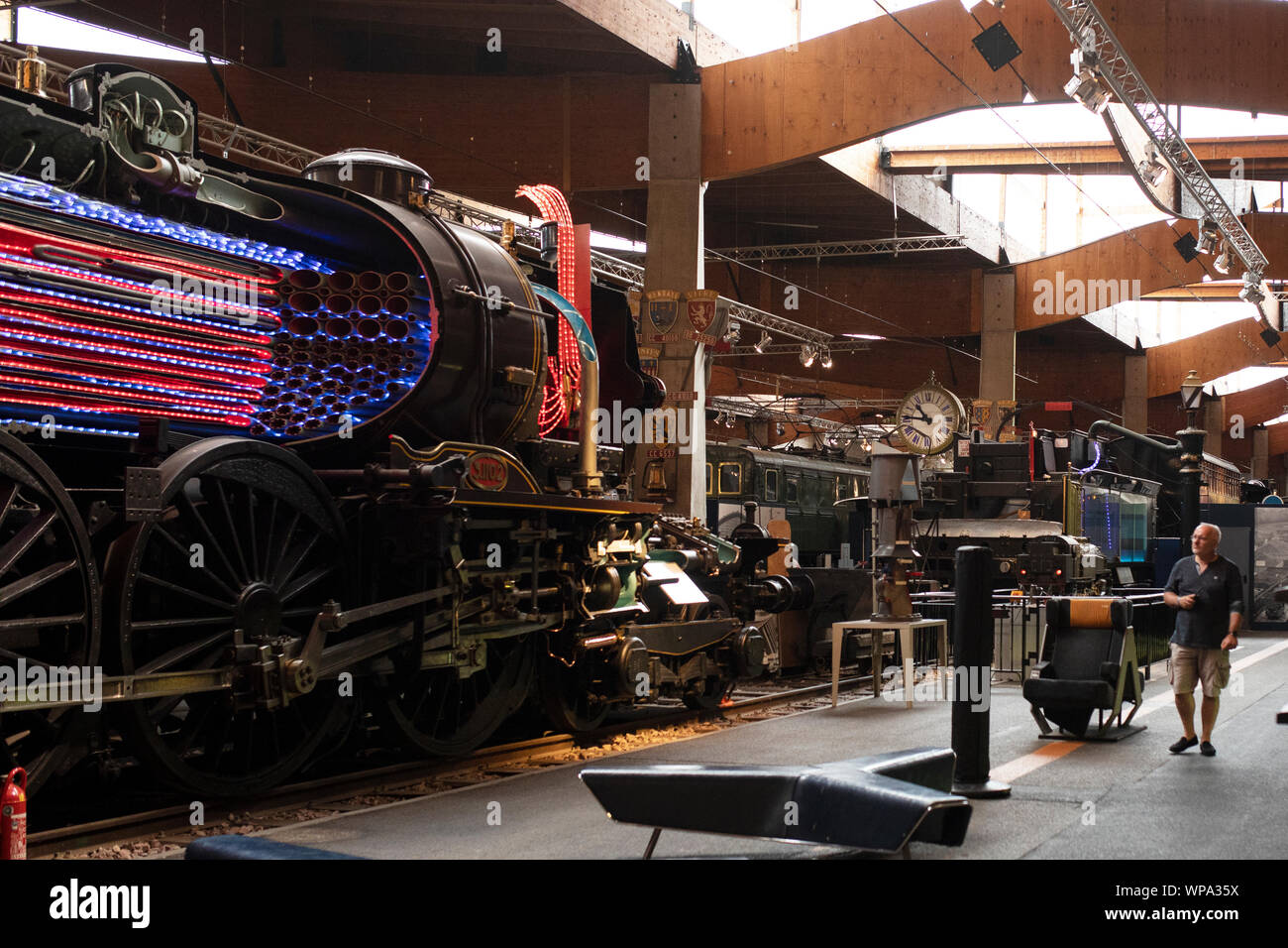 A man looks at the 232 Baltic no. 3 1102 Nord steam locomotive from 1911 at the Cité du Train museum in Mulhouse, France. Stock Photo