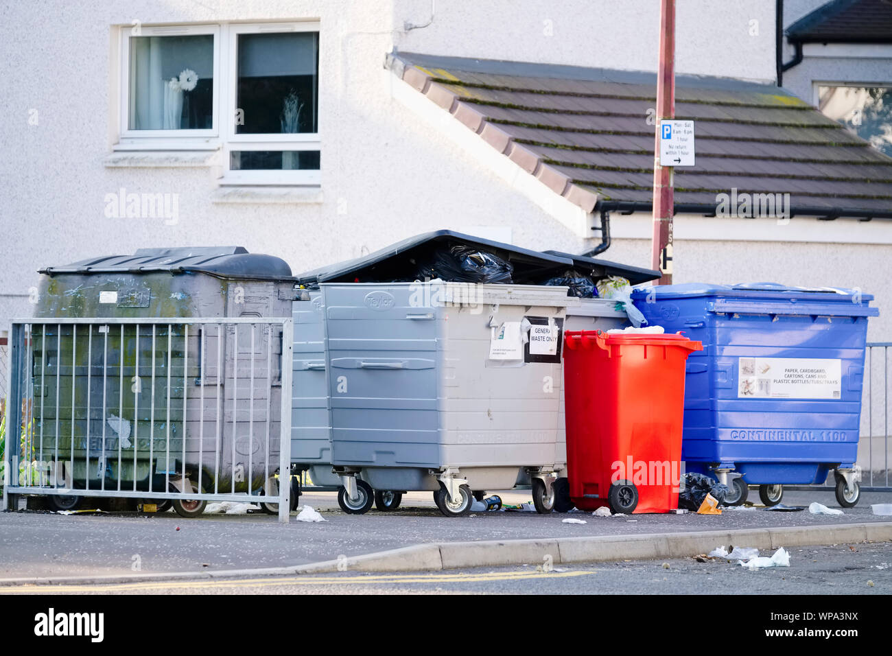 Wheelie bin collection strike at council estate compound enclosure