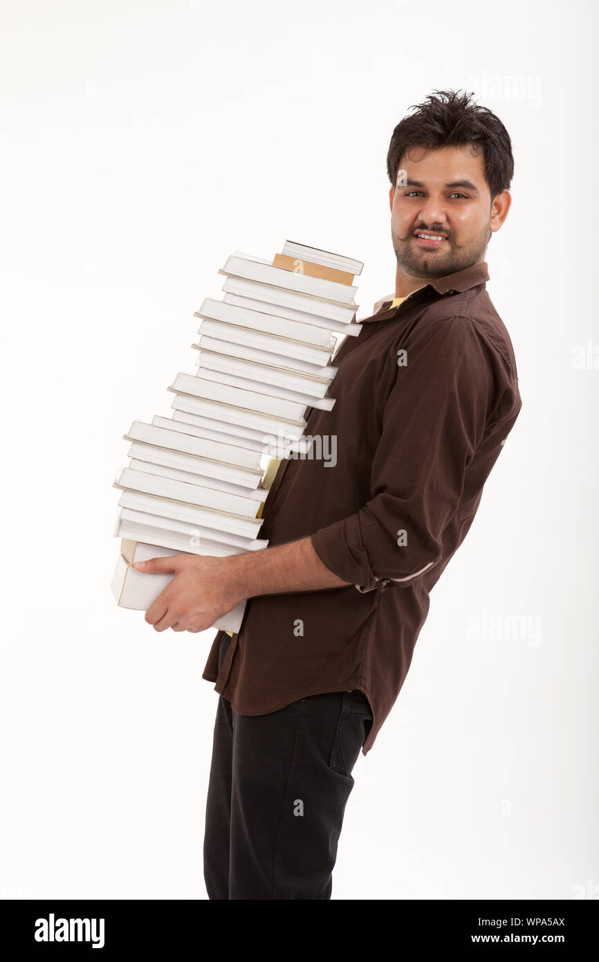 College student carrying stack of books Stock Photo Alamy