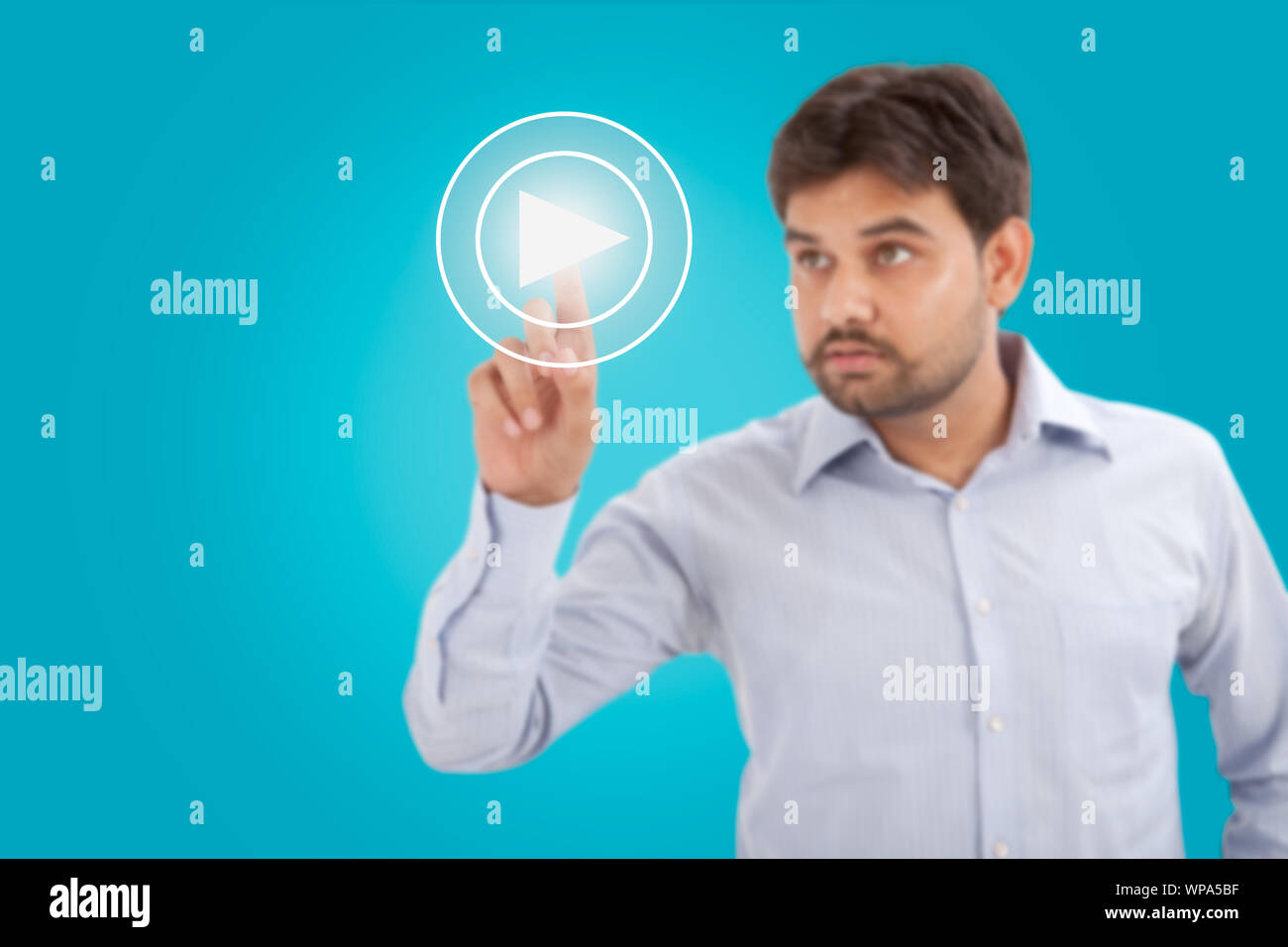 Businessman pressing startplay button on virtual screen Stock Photo