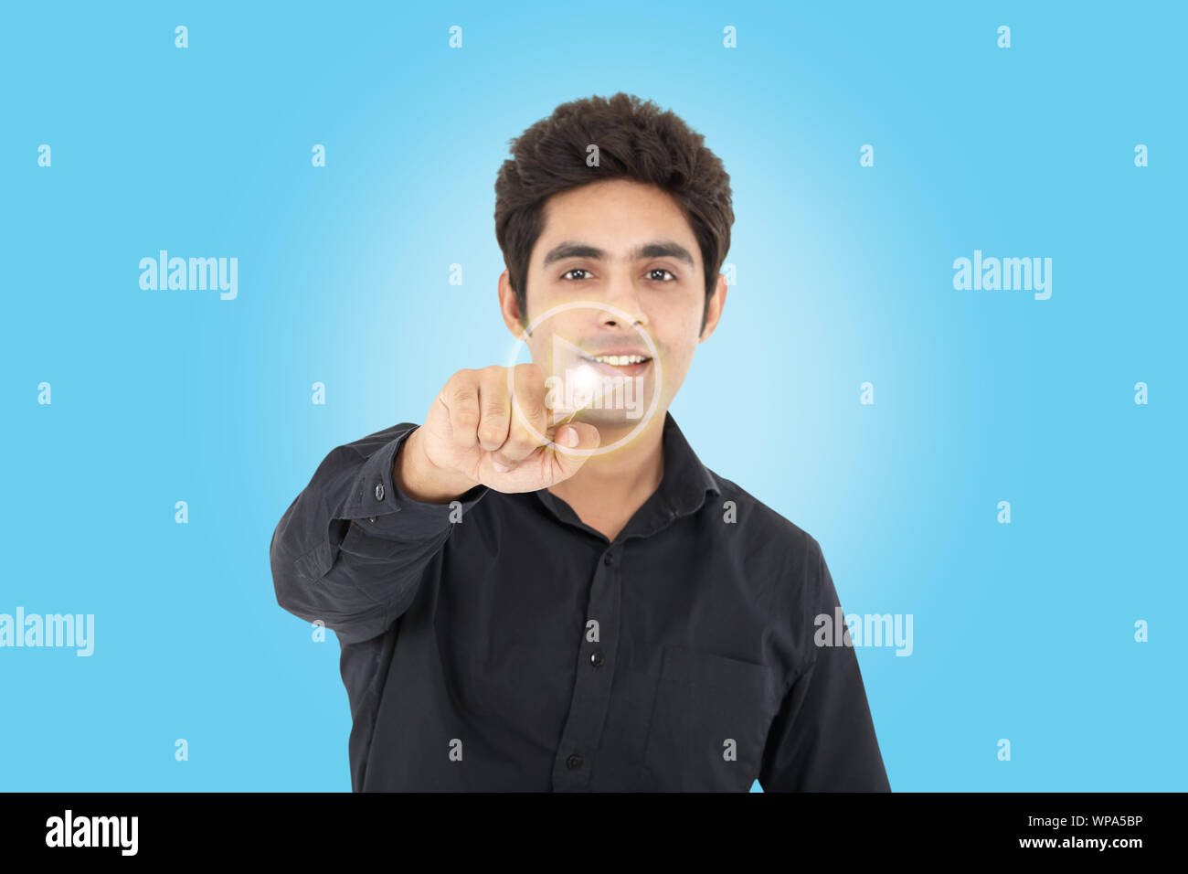 Businessman pressing startplay button on virtual screen Stock Photo