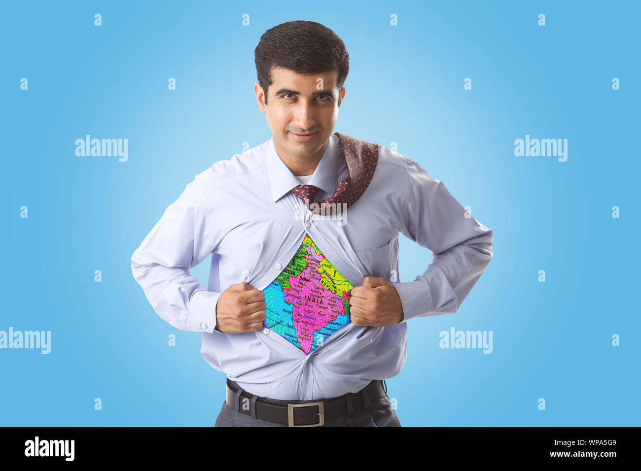 Super businessman tearing up his shirt to reveal Indian map on chest Stock Photo