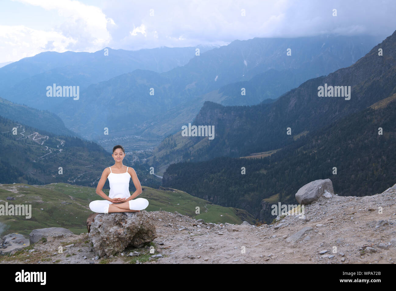 Young woman practicing yoga in a valley Stock Photo