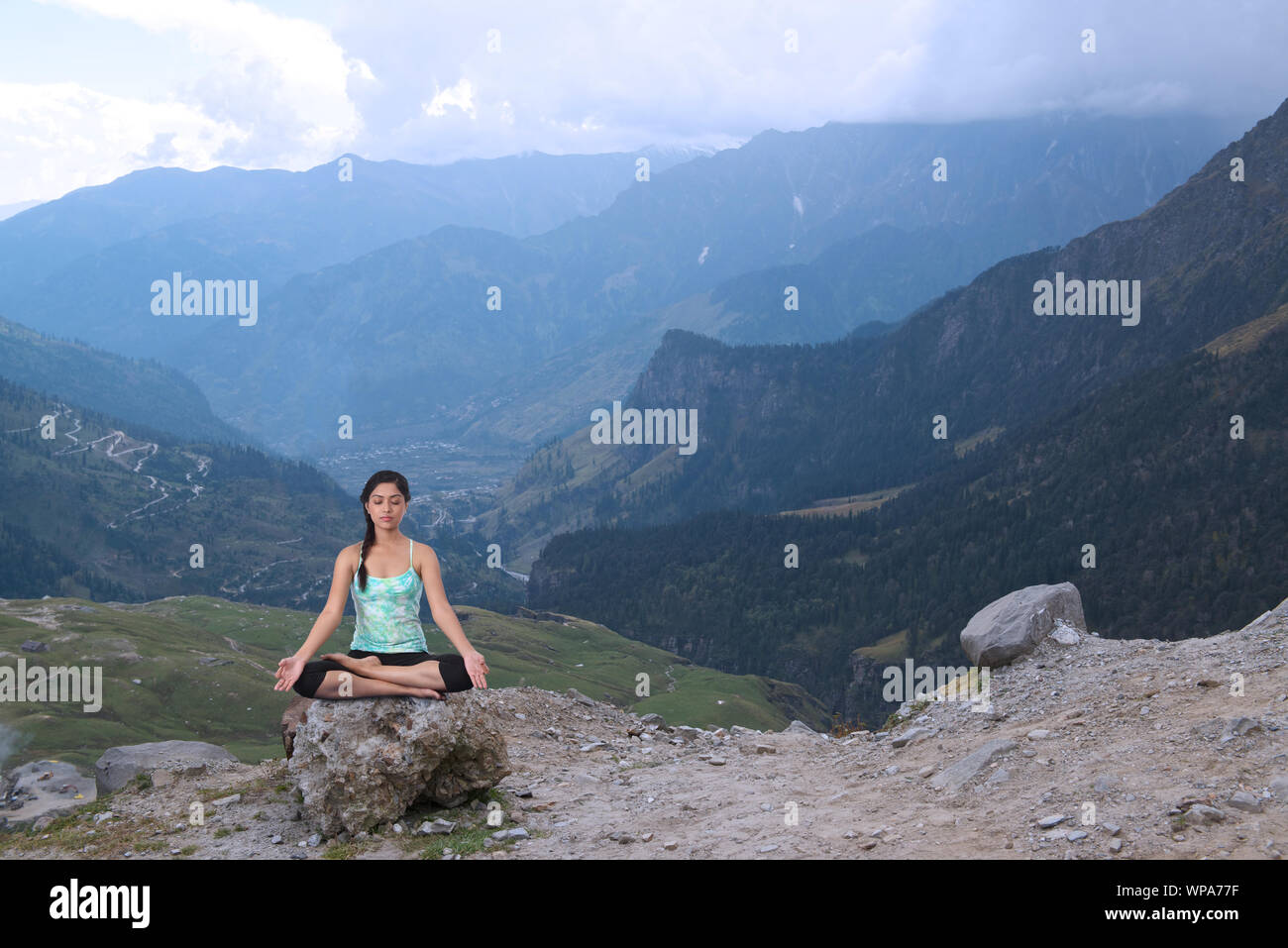 Young woman practicing yoga in a valley Stock Photo