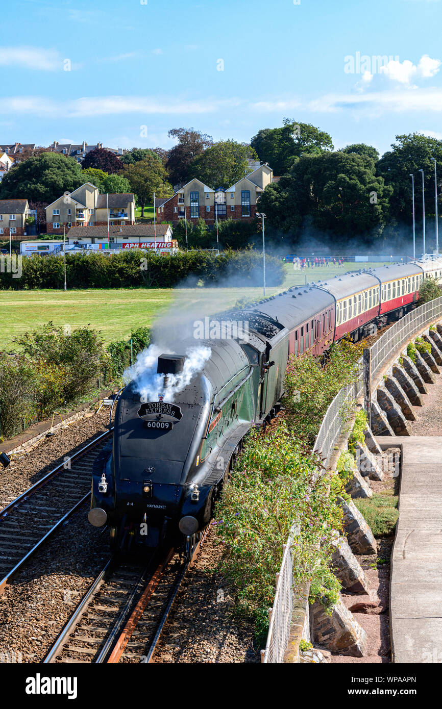 Steam locomotive 60009 Union of South Africa passes Teignmouth harbour with The Torbay Express. Stock Photo