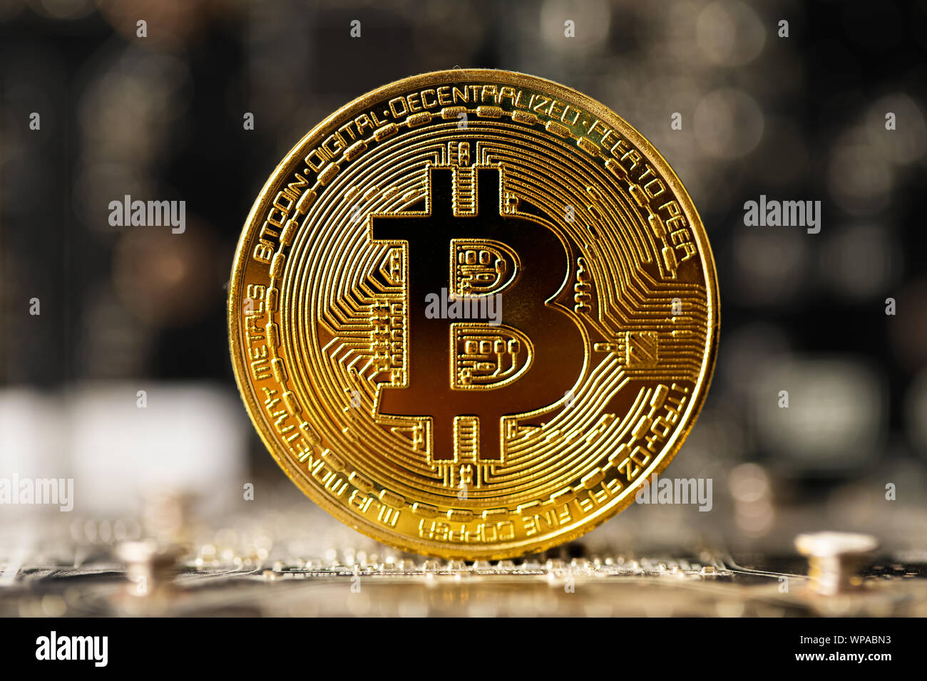 Dark gold bitcoin on crypto mining GPU circuit board computer hardware Stock Photo