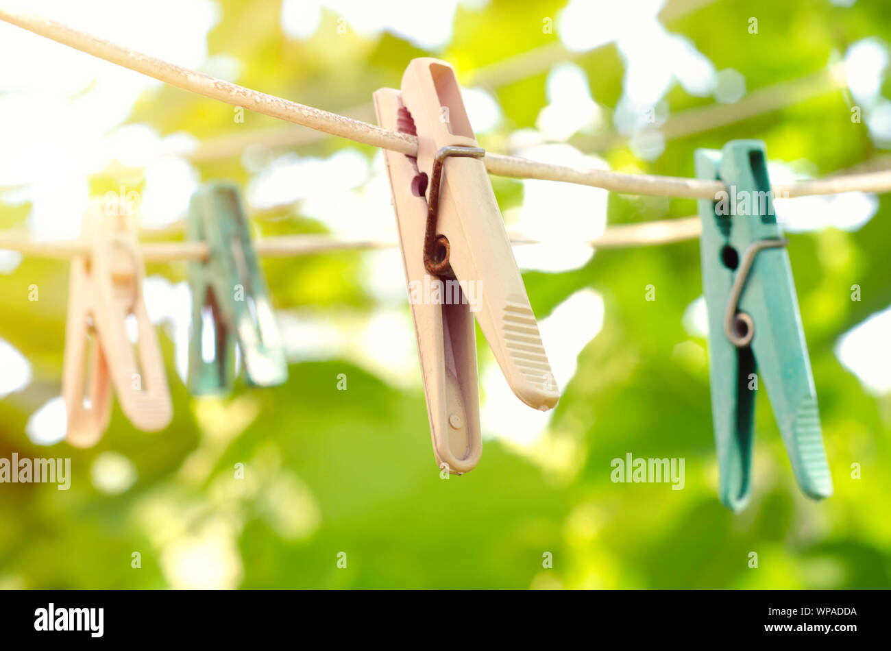old clothespins on the rope outdoors Stock Photo
