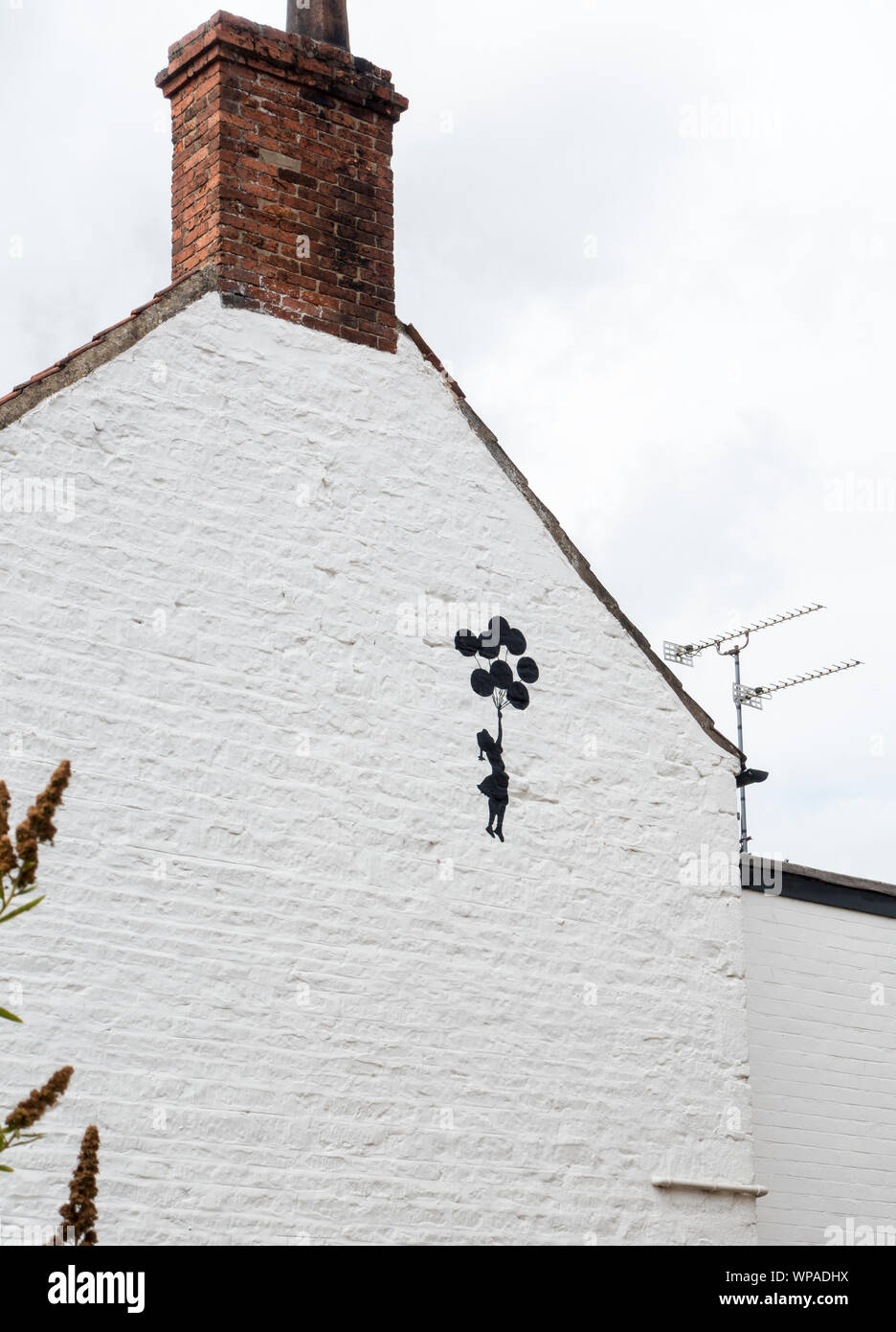 Balloon girl artwork on gable end wall Nettleham Lincoln 2019 Stock Photo