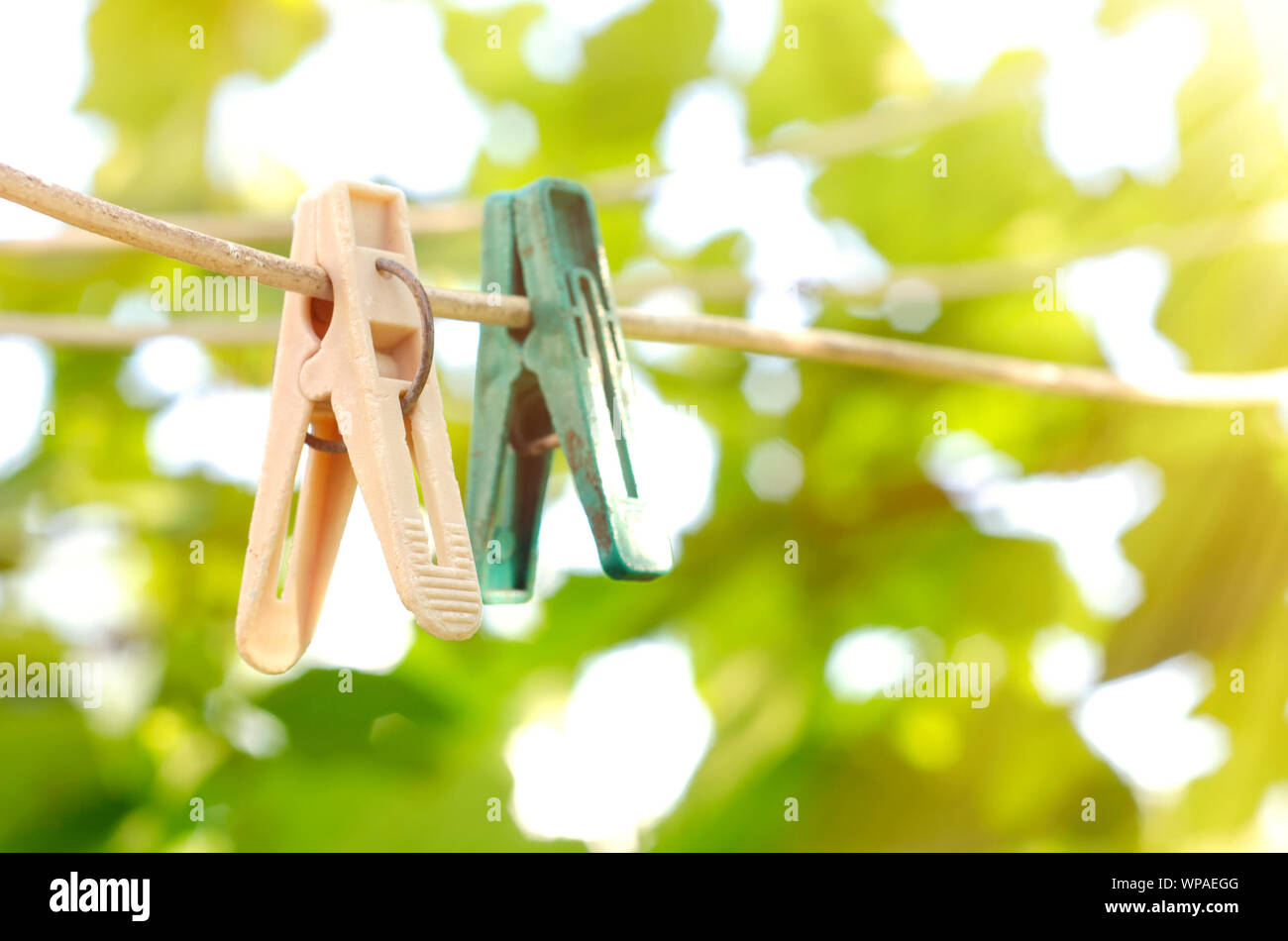 old clothespins on the rope outdoors Stock Photo