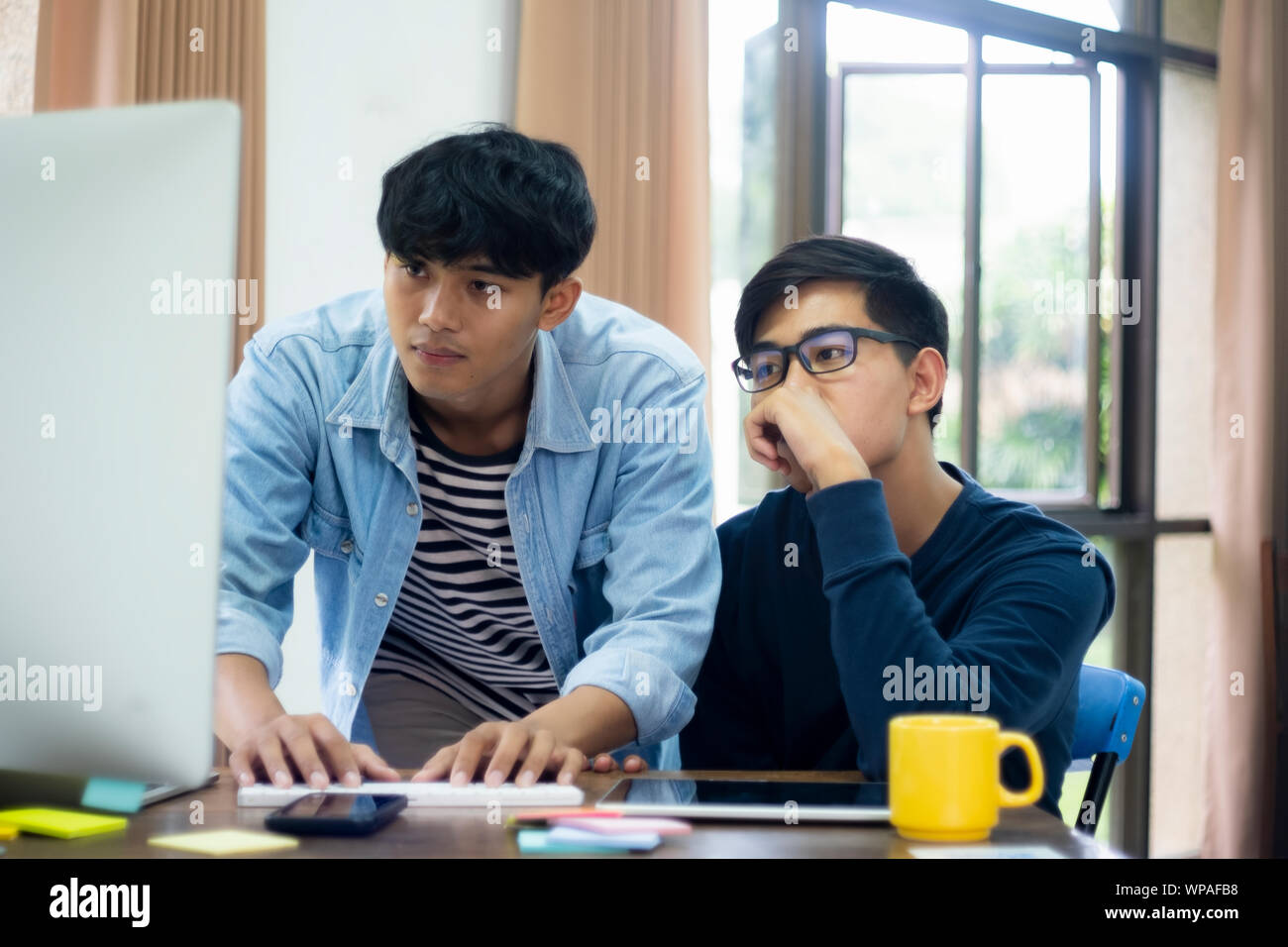 Programmers and developer teams are coding and developing software. Stock Photo