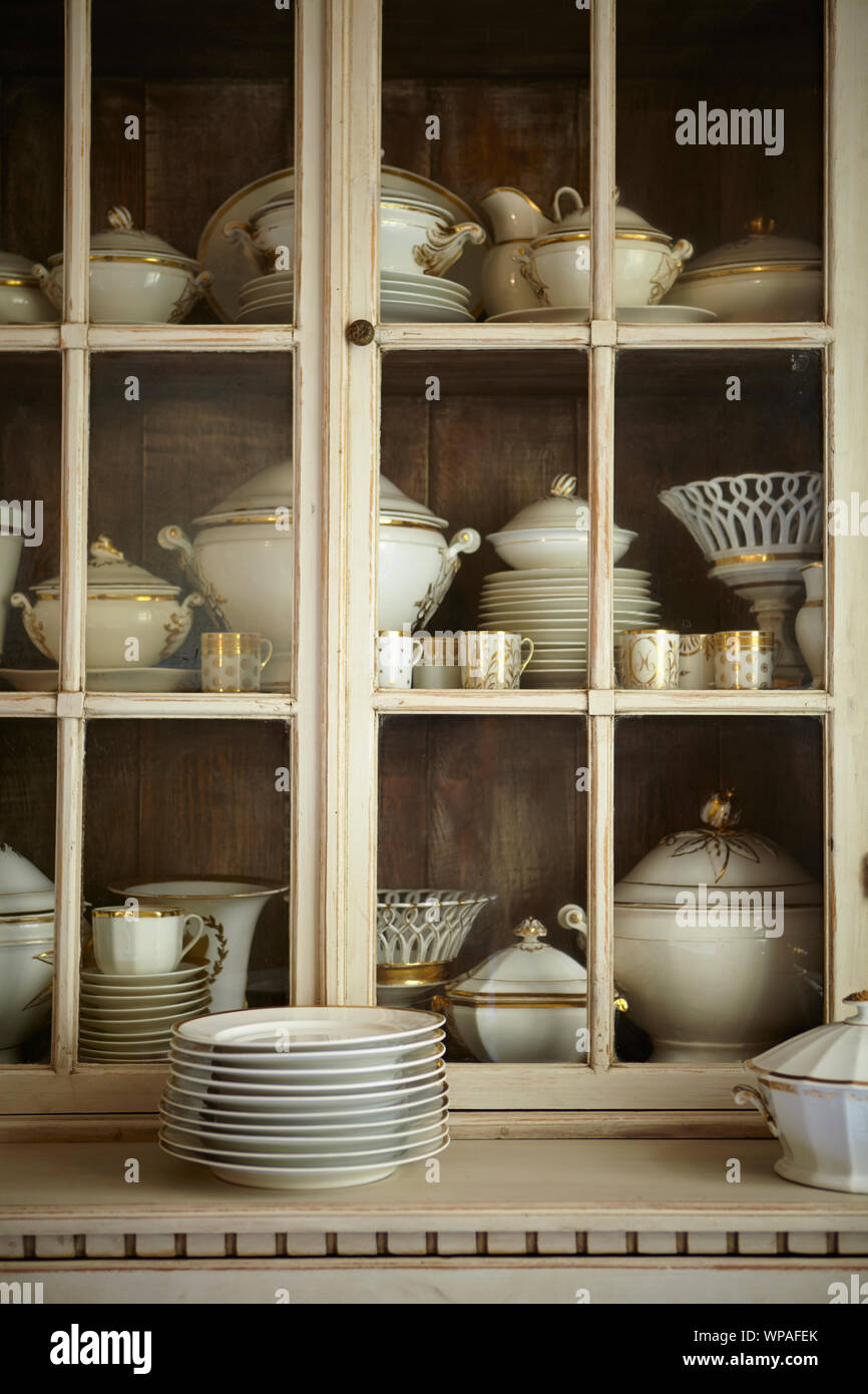 Cabinet filled with Bavarian white and gold china collection Stock Photo