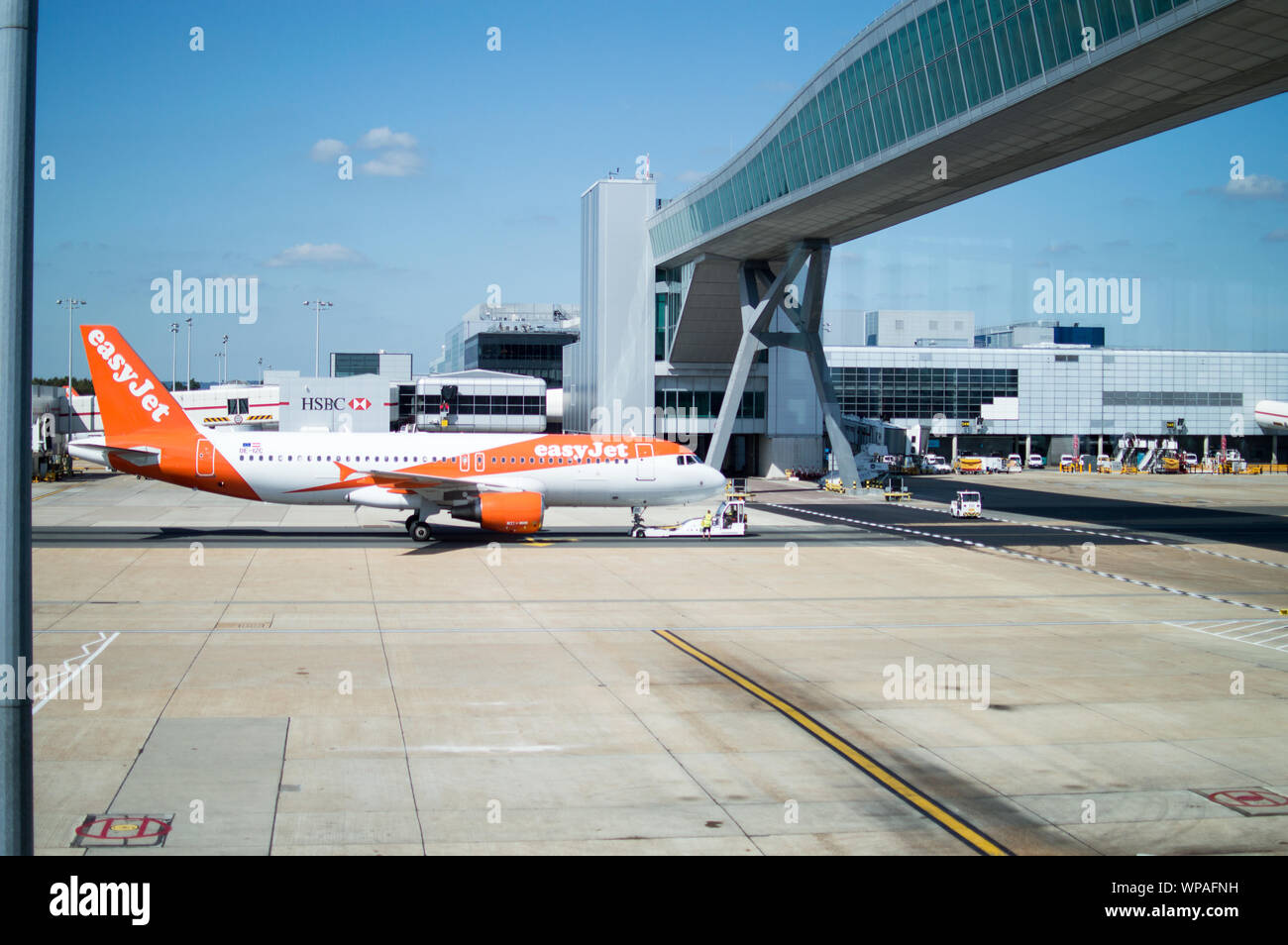 EasyJet aeroplane pushed by a tug at London Gatwick airport terminal Stock Photo Alamy