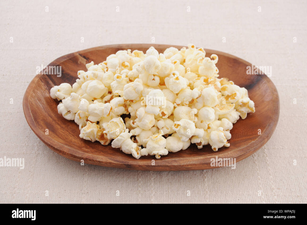 Popcorn on a plate isolated on table Stock Photo - Alamy