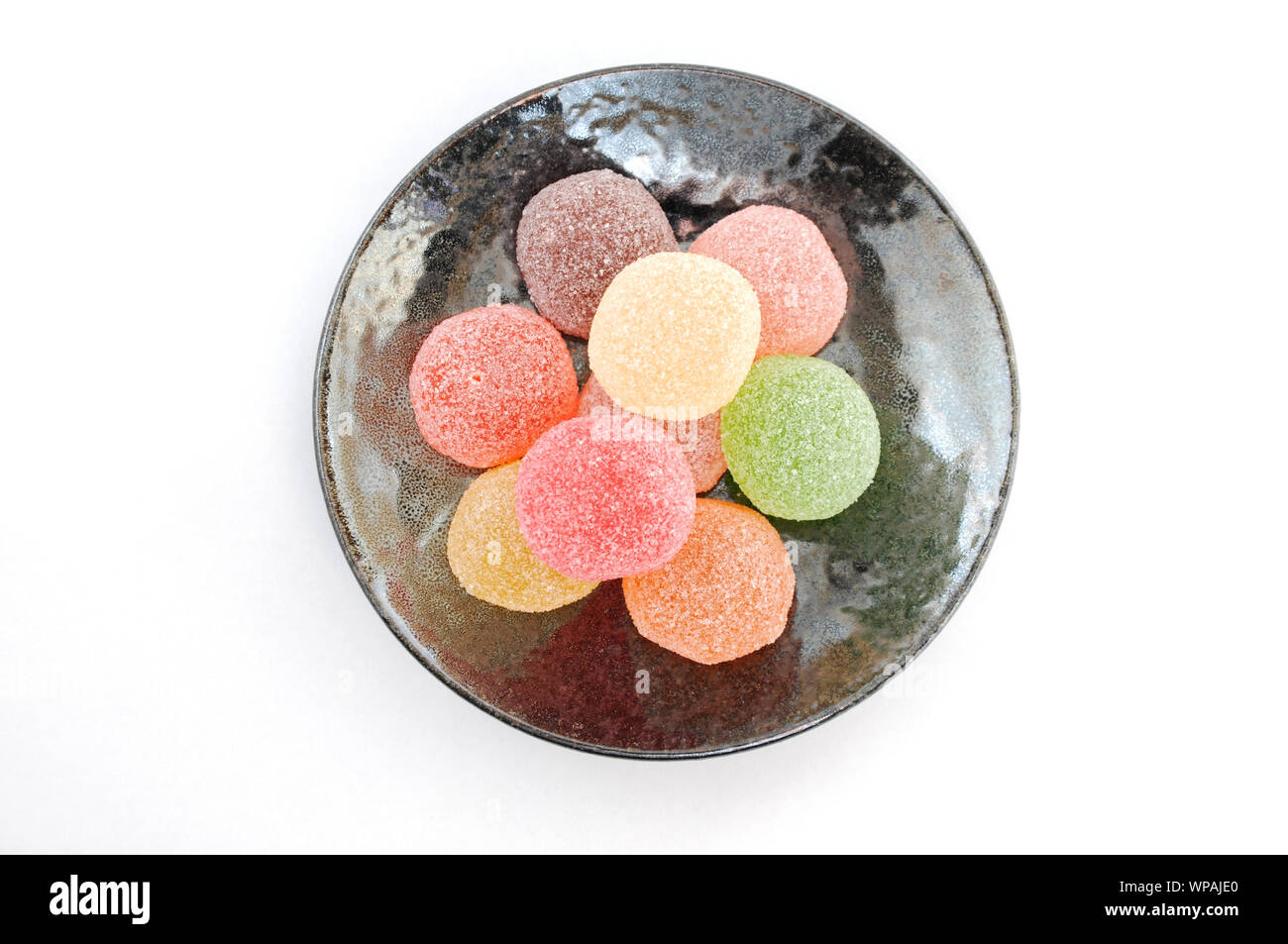 colorful candies jelly beans closeup isolated on a plate on white ...