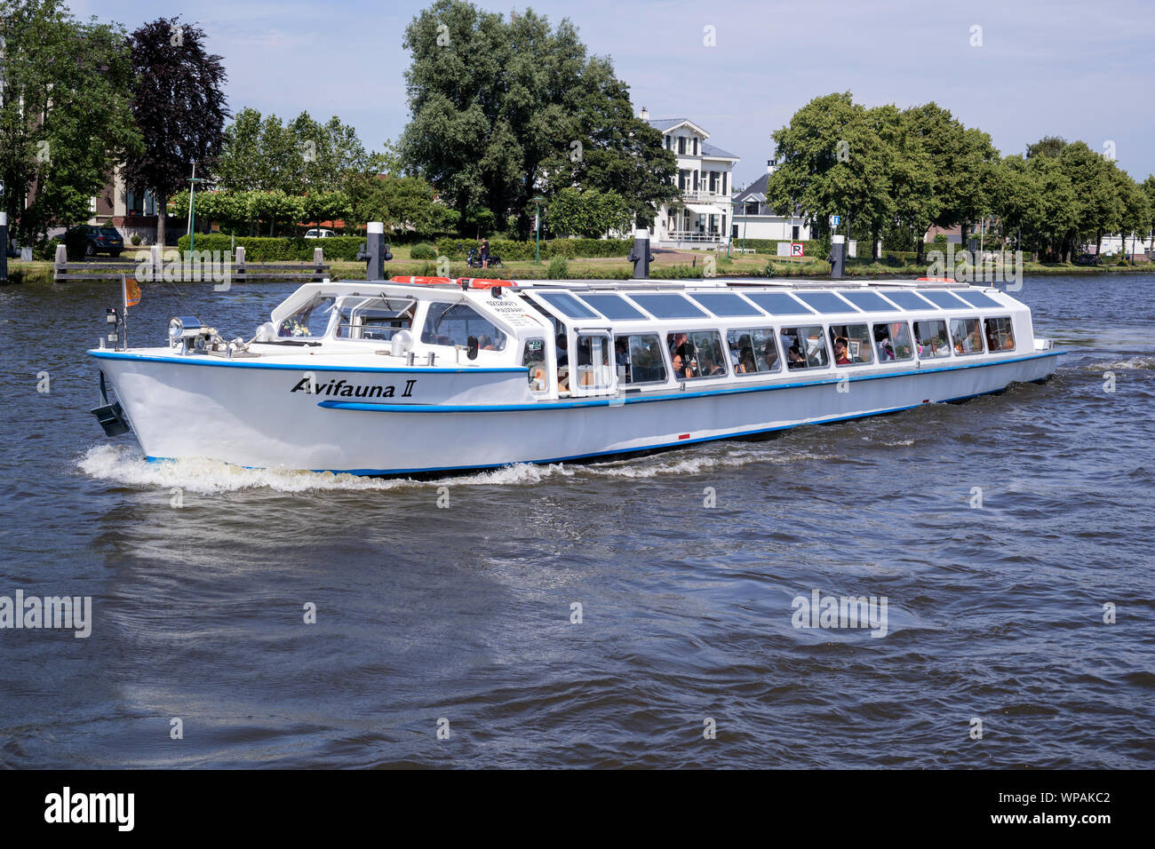 Excursion boat AVIVAUNA II on canal cruise. Van der Valk is the largest Dutch hospitality chain and also operates the Avifauna Bird Park. Stock Photo
