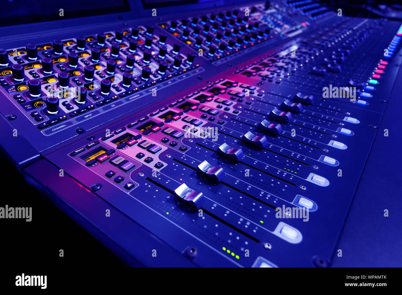 Professional audio studio sound mixer console board panel with recording ,  faders and adjusting knobs,TV equipment. Blue tone and close-up image Stock  Photo - Alamy