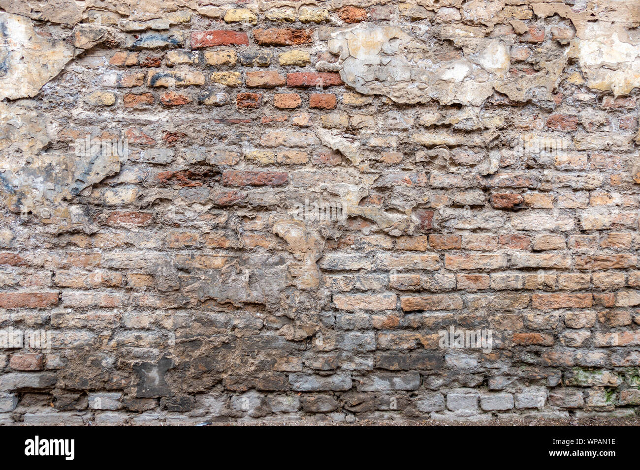 Old vintage dirty brick wall with peeling plaster texture background ...