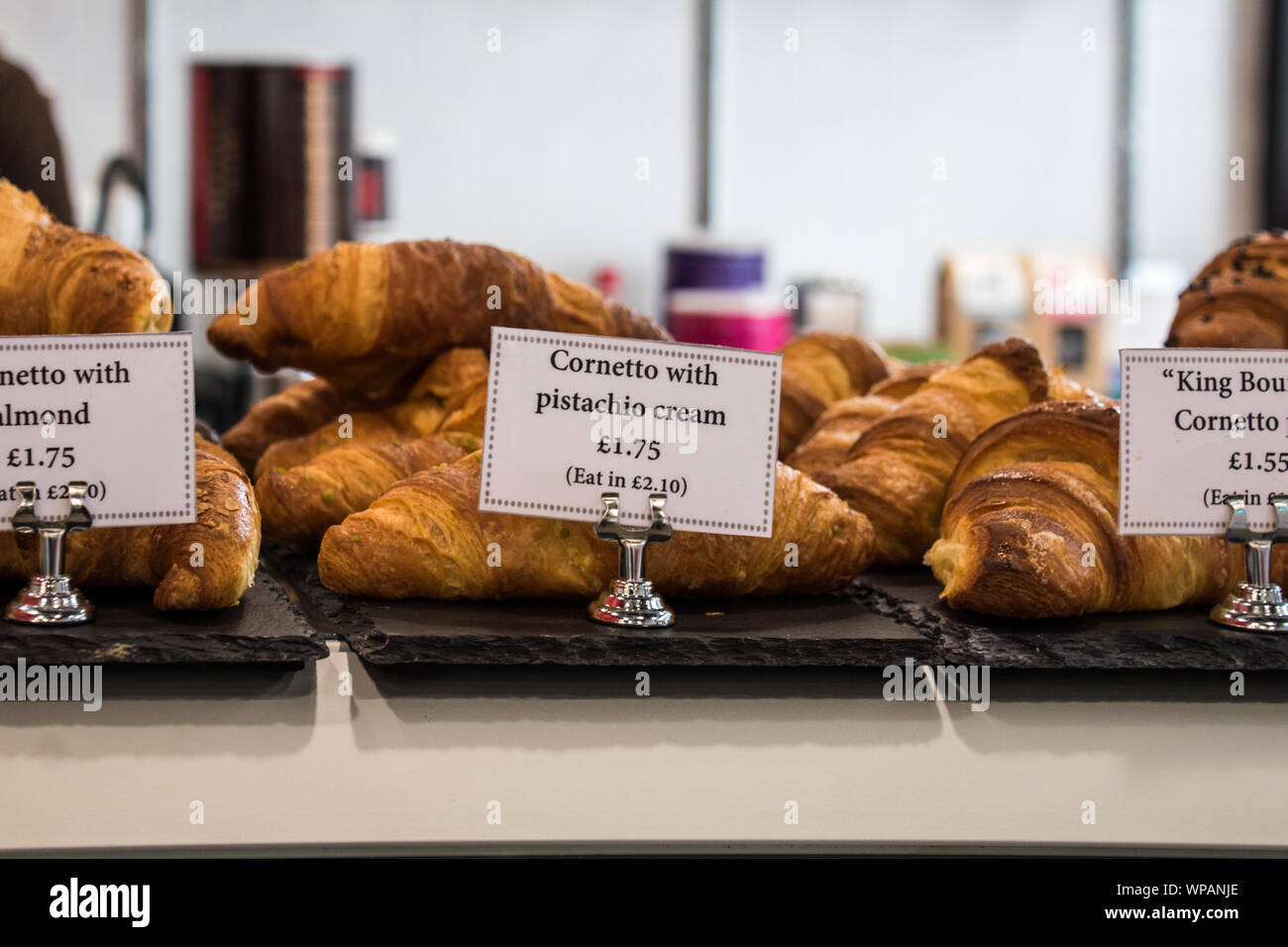 Pistachio cream filled Croissant on display in a store Stock Photo Alamy