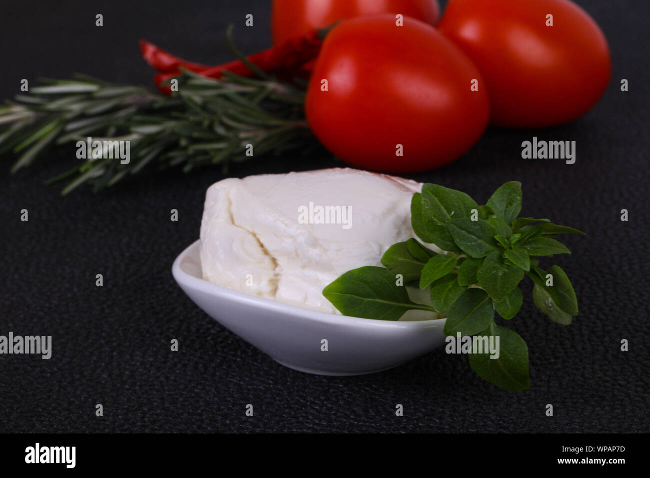 Italian Mozzarella cheese ball served basil and tomatoes Stock Photo Alamy