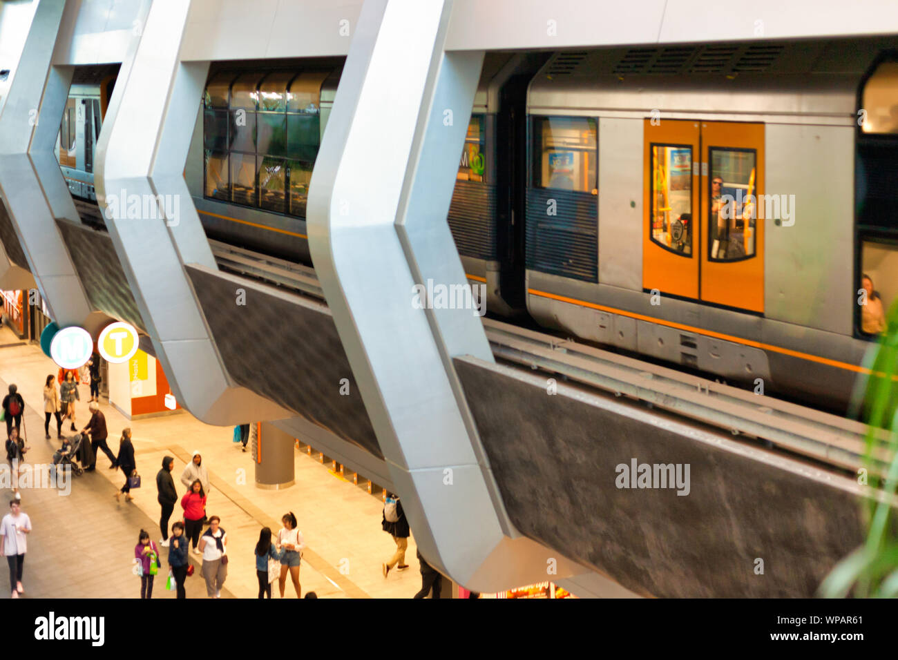 Modern subway platform with train and people indoors Stock Photo