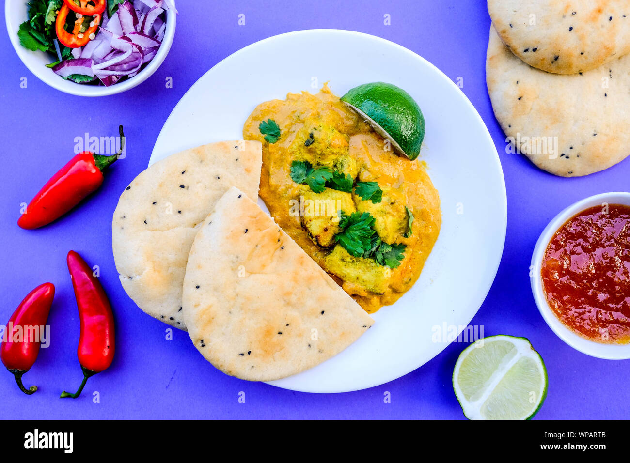 Traditional Indian Chicken Korma Curry Meal With Naan Bread Stock Photo