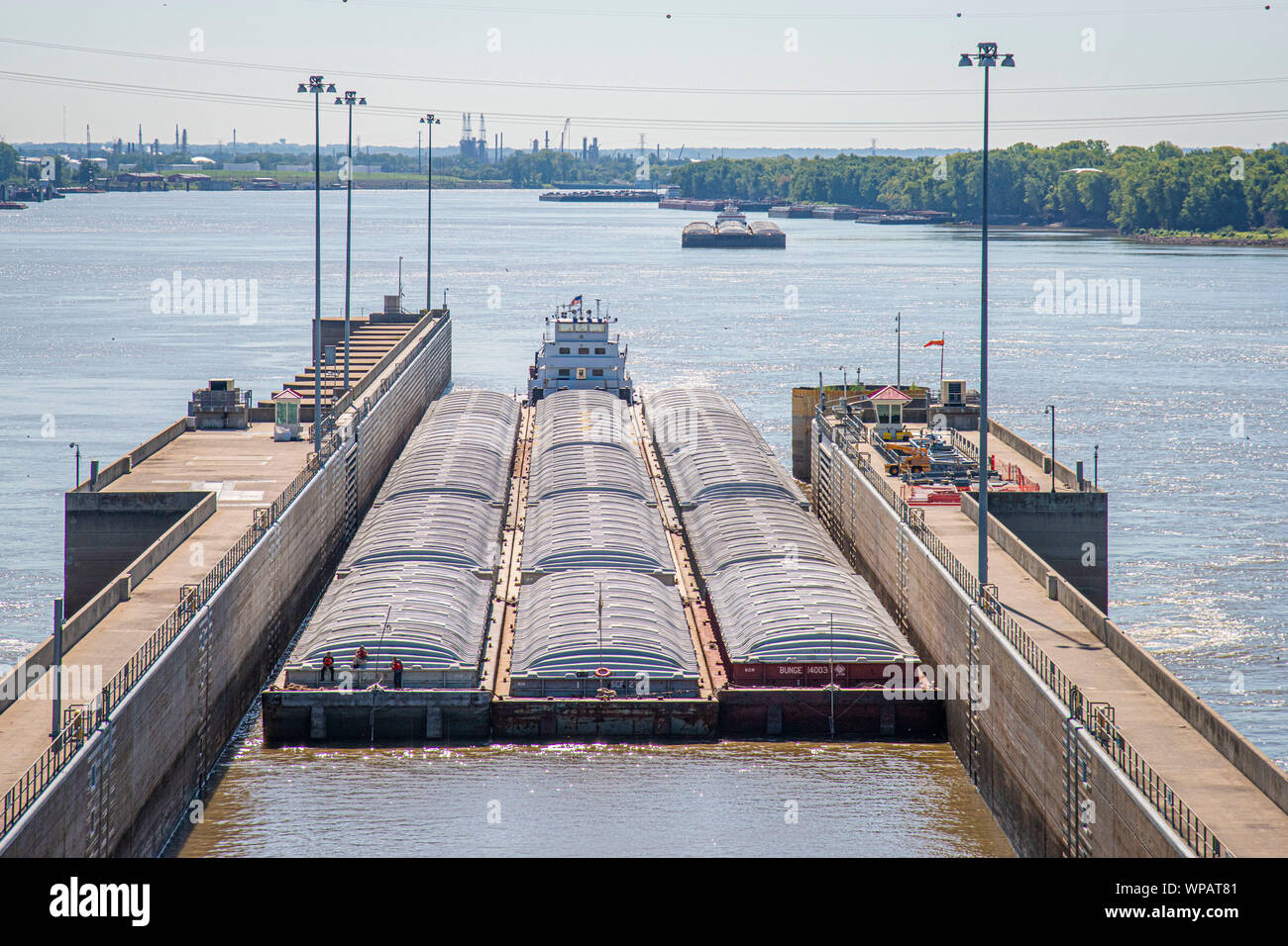 Barge traffic on the Mississippi River at the Melvin Price Locks and Dam  Facility August 29, 2019 near Alton, Illinois, USA. A typical barge carries  1500 tons of cargo, which is 15