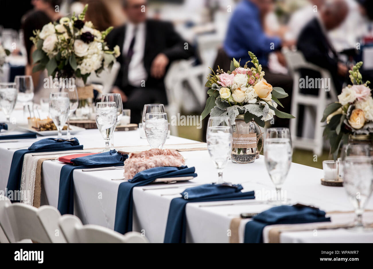 Table Set Up For Wedding Reception With People Out Of Focus In