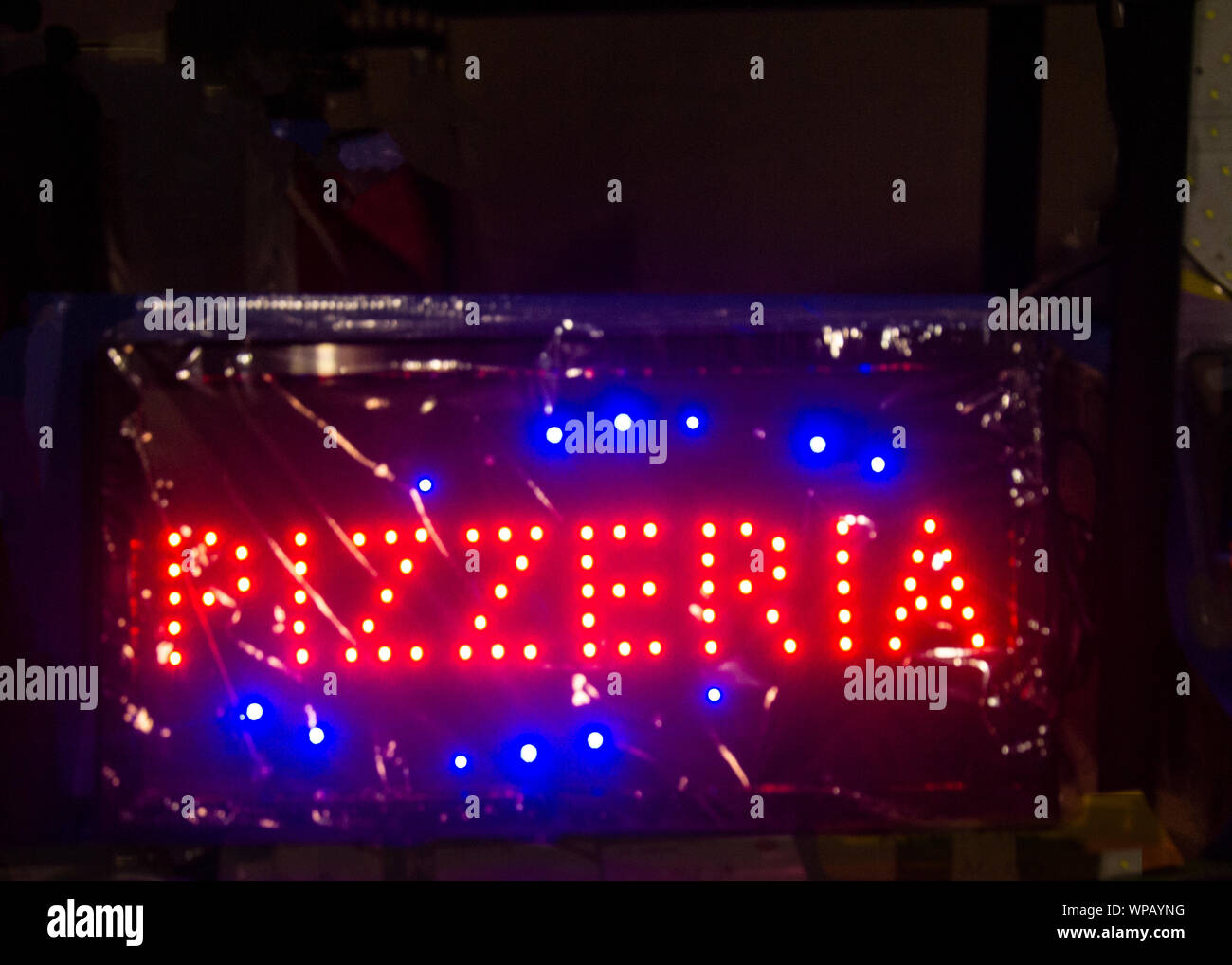 panel with colored LED lights that make up the word pizzeria Stock Photo