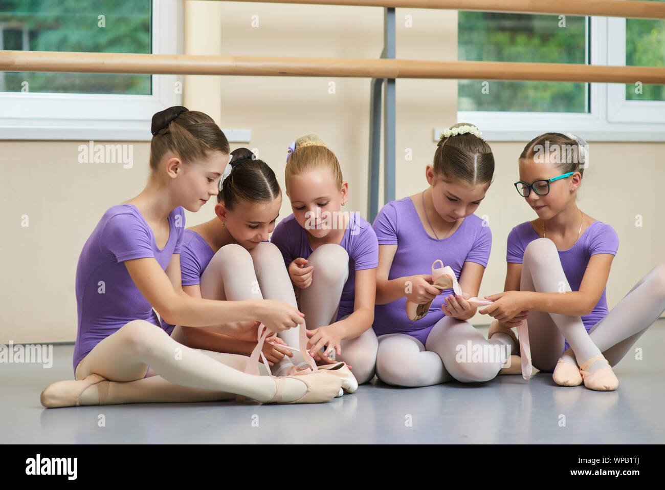 Cute little ballet dancers sitting on floor Stock Photo Alamy