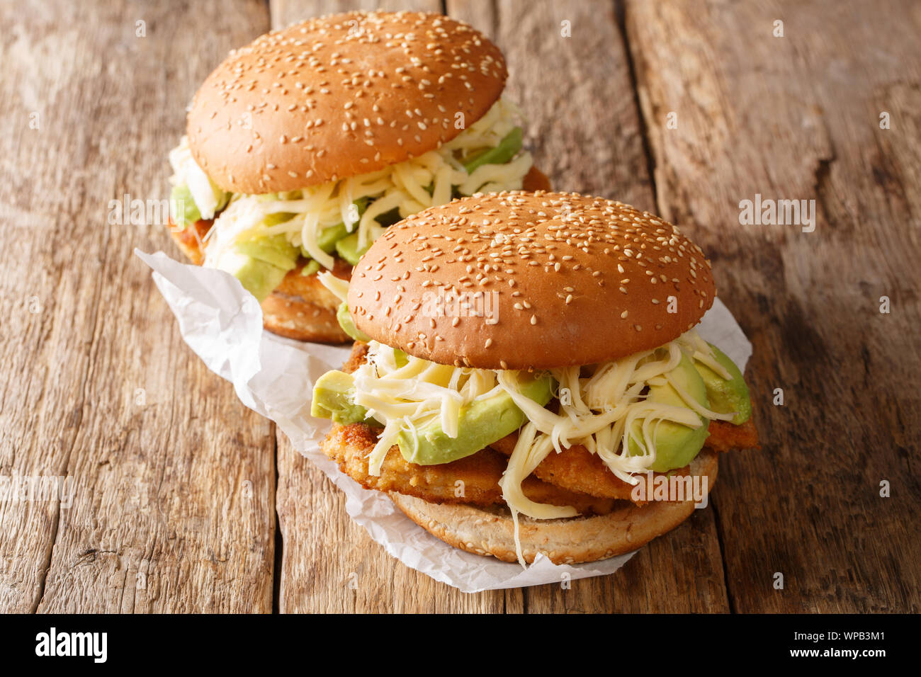 Mexican traditional sandwich with breaded meat, cheese and vegetables close-up on the table. horizontal Stock Photo