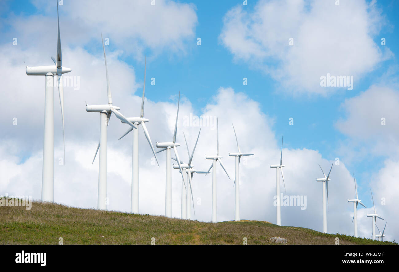 Wind power plant on hilltop in Europe Stock Photo