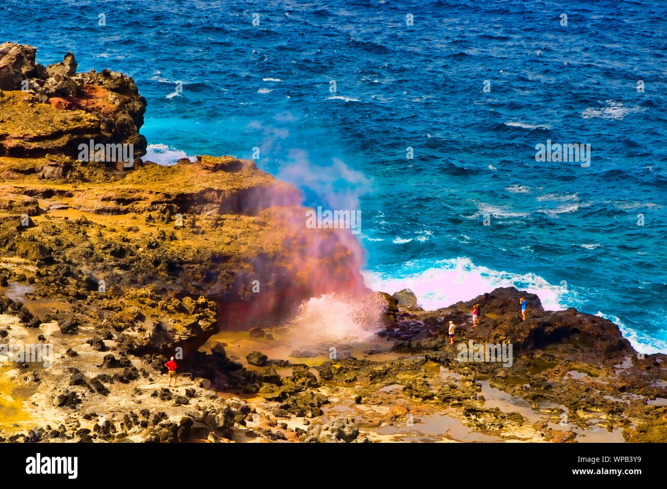 Tourists looking at a blow hole on the Maui coastline, Hawaii, USA Stock Photo