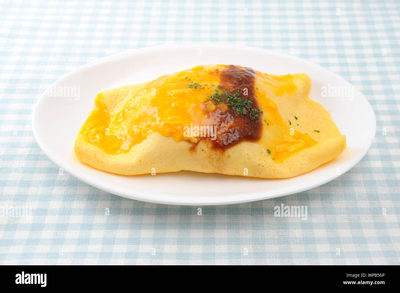 omuraisu omu rice omelet japanese food on plate isolated on table Stock Photo