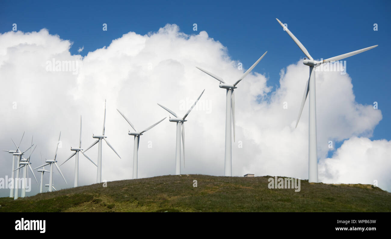 Onshore wind power plant on hill Stock Photo