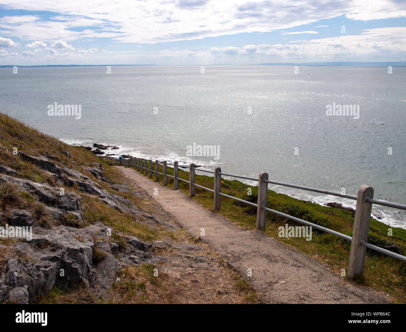 A view looking east on the coastal footpath on Gower with Devon on the horizon, between Limeslade and Rotherslade Bay, Swansea, Wales, UK. Stock Photo