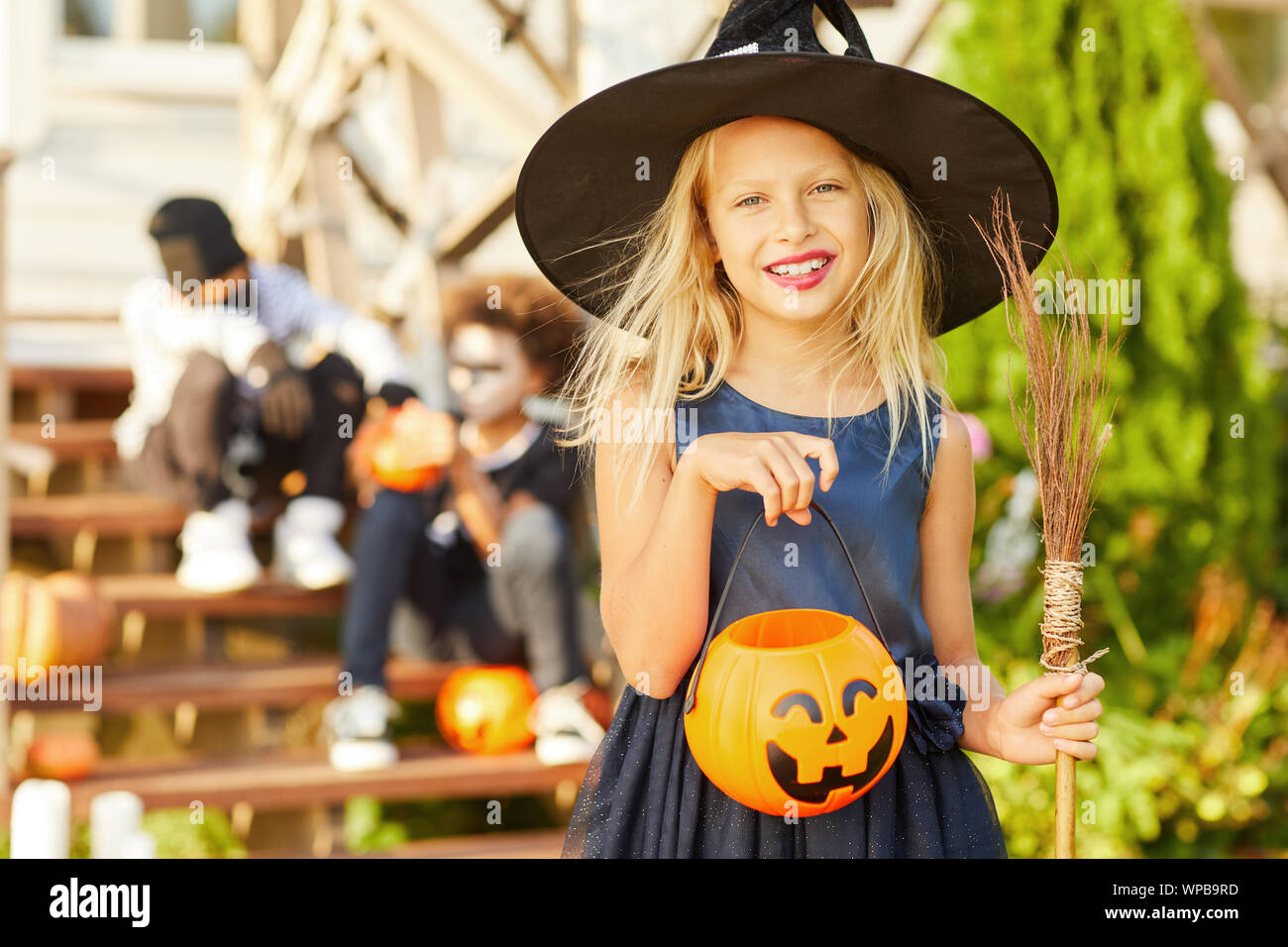 Waist up portrait of cute little girl wearing Halloween costume looking ...